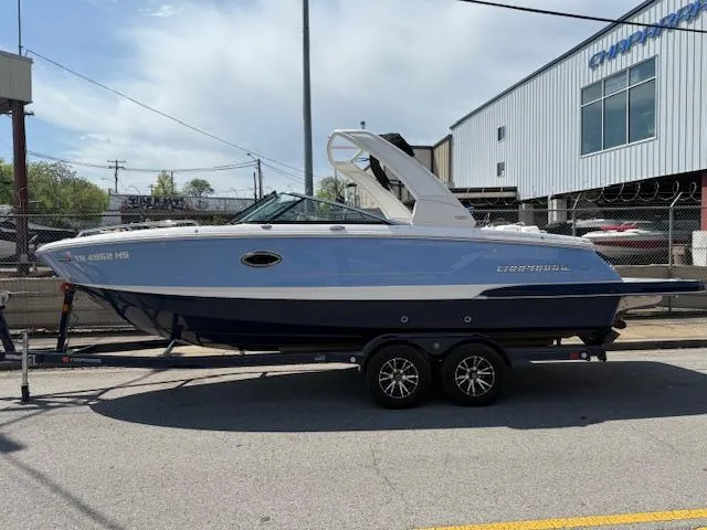Slide: The Image of 2023 Chaparral 267 SSX boat on trailer, parked outdoors near a building. - 4
