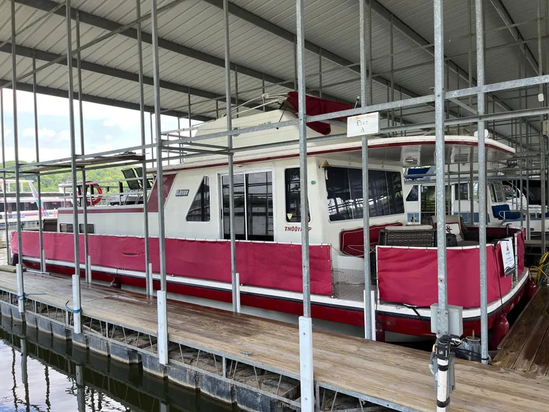 Slide: The Image of Houseboat docked in marina, Gibson Standard model, 1988, with red and white exterior. - 1