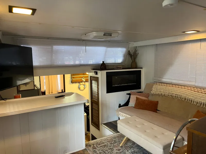 Slide: The Image of Cozy 1988 Gibson Standard interior with modern decor, featuring a sofa, TV, and stylish accents. - 10