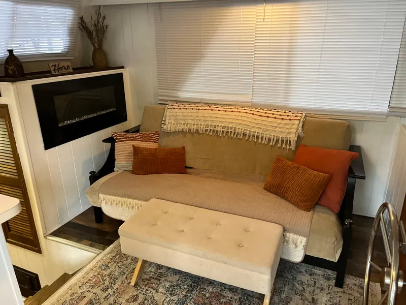 Slide: The Image of Cozy living room with a beige sofa, cushions, and a decorative rug. - 12