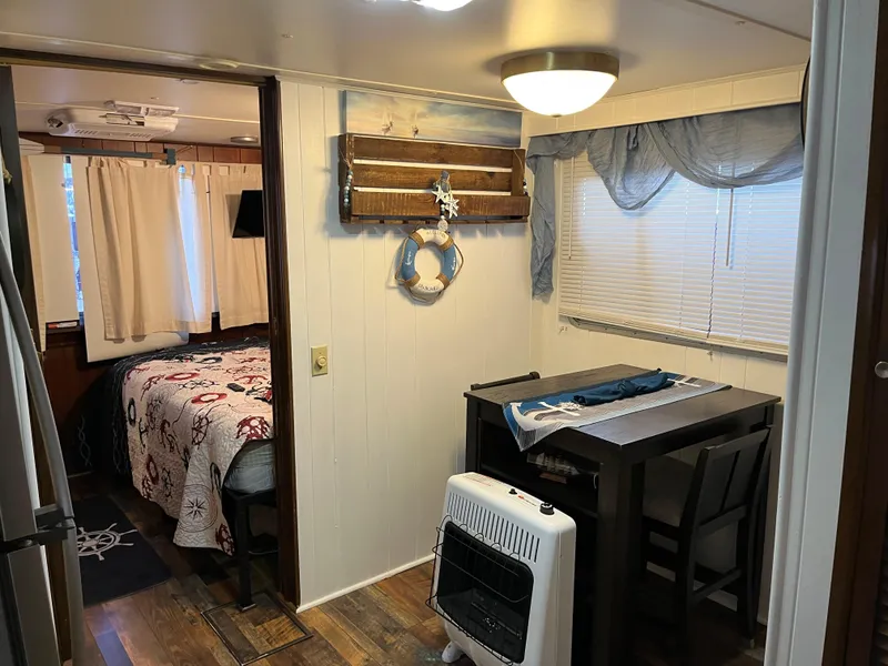 Slide: The Image of Cozy 1988 Gibson Standard interior with dining area, bedroom, and nautical decor. - 21