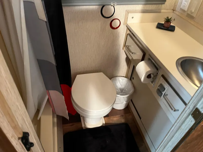 Slide: The Image of Compact bathroom with toilet, sink, and shower in a 1988 Gibson Standard model. - 26