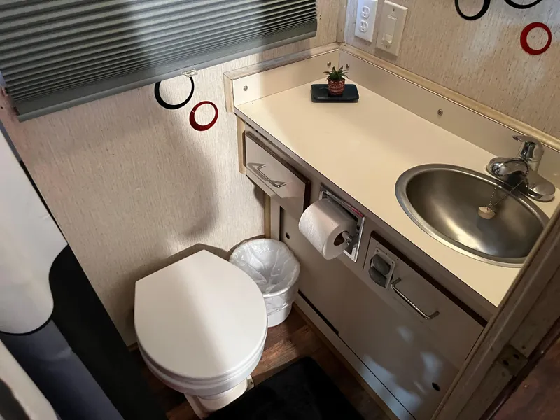 Slide: The Image of Compact bathroom with sink, toilet, and countertop in a 1988 Gibson Standard model. - 28