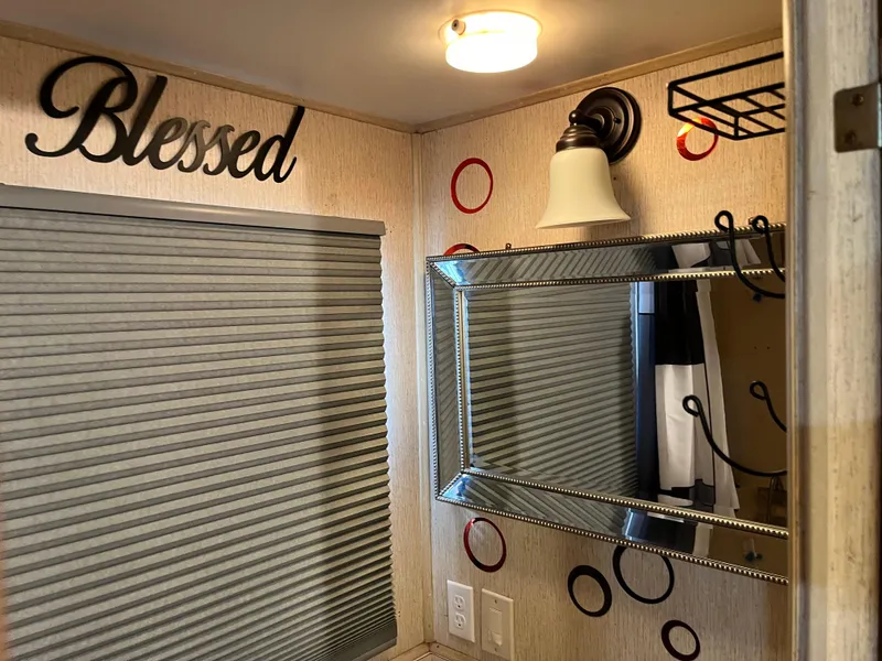 Slide: The Image of Bathroom with "Blessed" decor, mirror, light fixture, and patterned wall. - 29