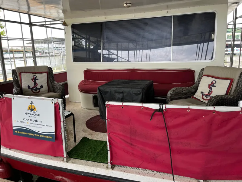 Slide: The Image of 1988 Gibson Standard boat interior with red seating, anchor-themed decor, and covered windows. - 3