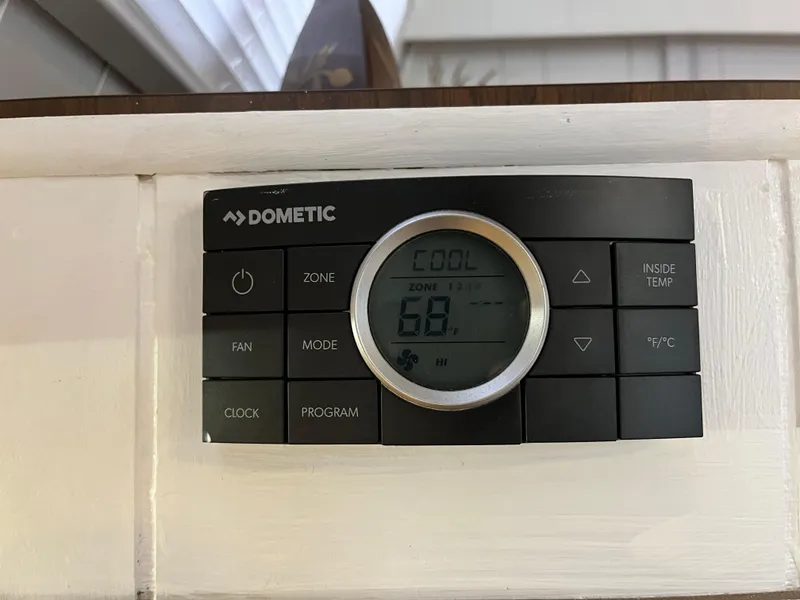 Slide: The Image of Digital Dometic thermostat set to cool at 68 degrees, mounted on a white wall. - 33