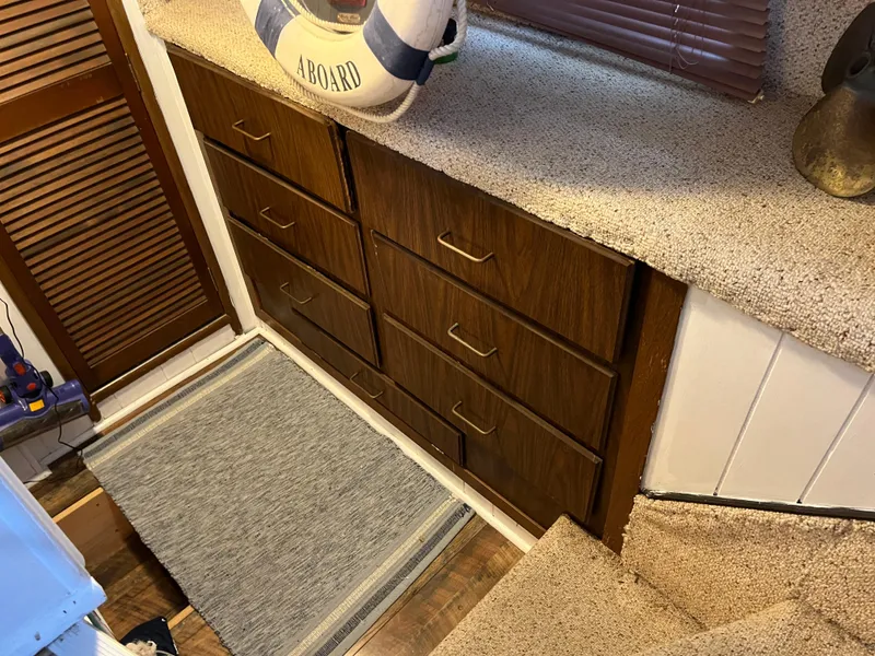 Slide: The Image of 1988 Gibson Standard interior with wooden drawers, carpeted stairs, and nautical decor. - 35