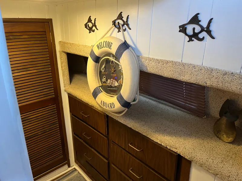 Slide: The Image of Nautical-themed interior with "Welcome Aboard" life preserver, wooden cabinets, and fish wall decor. - 36