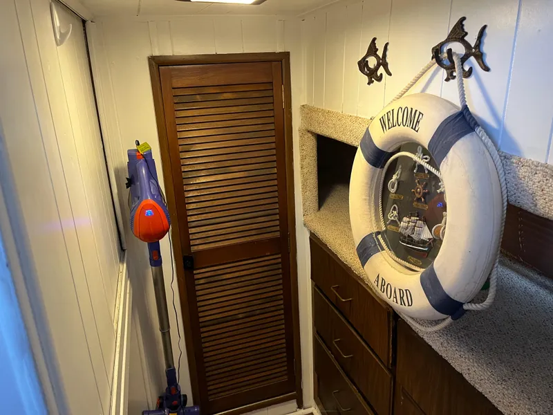 Slide: The Image of Nautical-themed boat interior with life preserver, wooden door, and storage cabinets. - 37