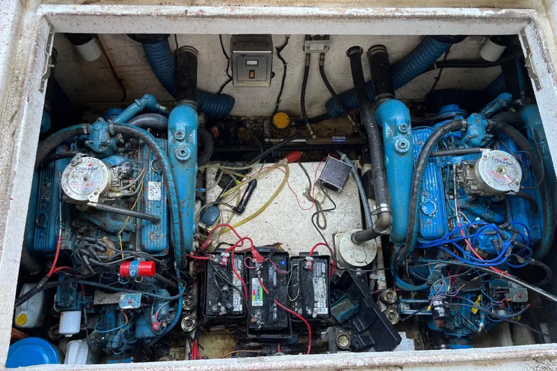 Slide: The Image of Engine compartment of a 1988 Gibson Standard boat with dual blue engines and batteries. - 42