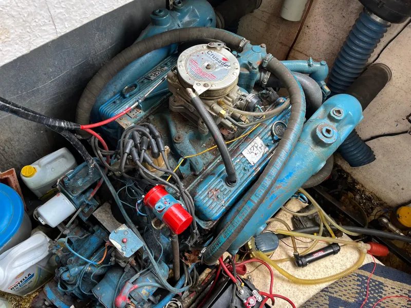 Slide: The Image of 1988 Gibson Standard engine with blue components and wiring in a workshop setting. - 44