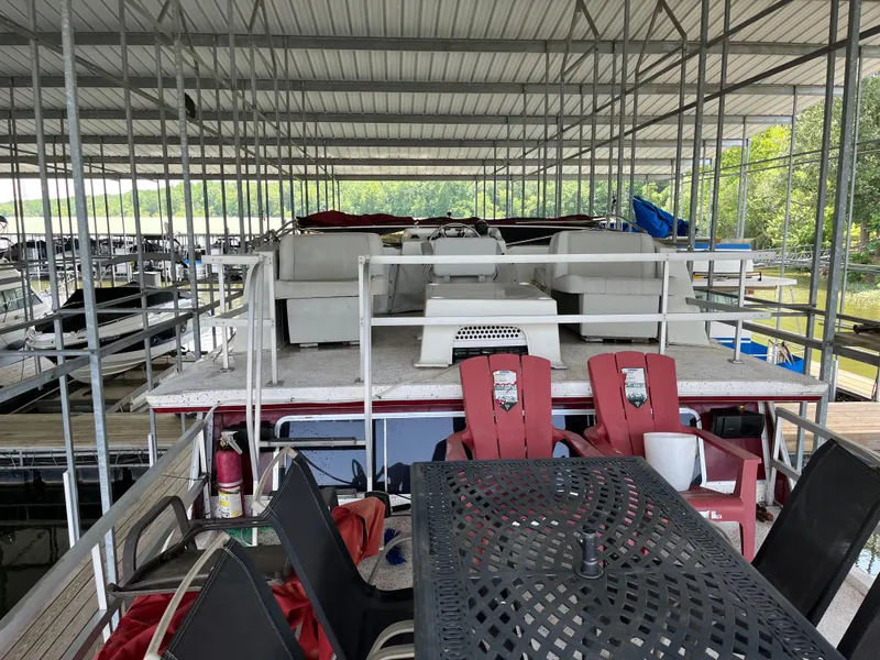 Slide: The Image of 1988 Gibson Standard houseboat with outdoor seating under covered dock. - 5