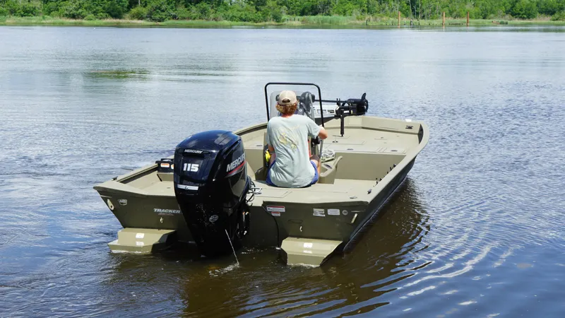 Slide: The Image of 2024 Tracker Grizzly 2072 SC boat on a calm lake, rear view. - 4