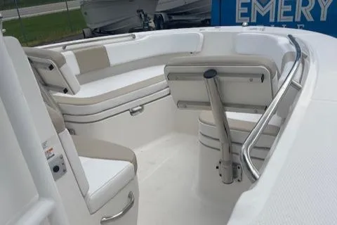 Slide: The Image of 2017 Robalo R200 Center Console boat interior with cushioned seating and stainless steel railings. - 3