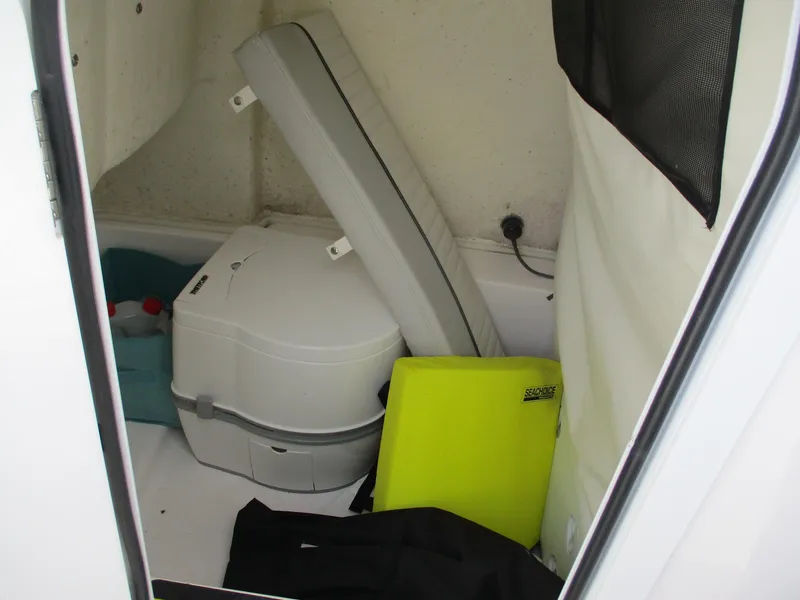 Slide: The Image of Interior storage area of 2022 Sea Fox 228 Commander boat with portable toilet and gear. - 12