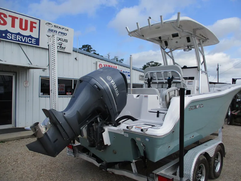 Slide: The Image of 2022 Sea Fox 228 Commander boat with Yamaha engine on trailer, parked outside service center. - 3