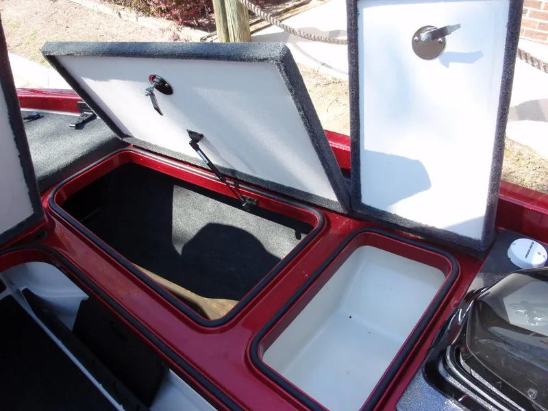 Slide: The Image of 2017 Ranger Z518 Comanche storage compartments with open lids, showcasing interior space. - 10