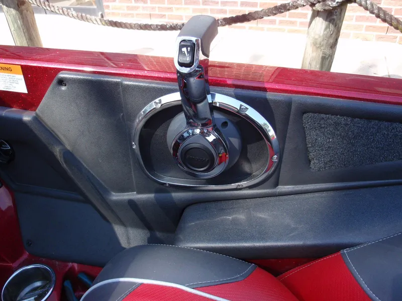 Slide: The Image of 2017 Ranger Z518 Comanche boat throttle control in red and black interior. - 12