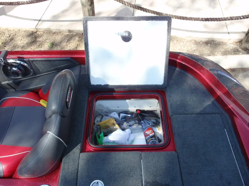 Slide: The Image of 2017 Ranger Z518 Comanche boat storage compartment with various items inside. - 18