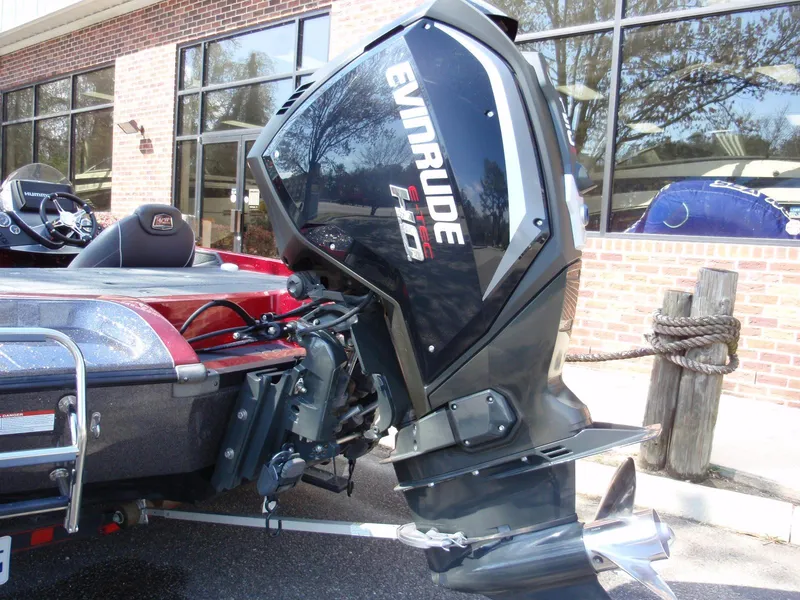 Slide: The Image of 2017 Ranger Z518 Comanche boat with Evinrude motor, parked outside a building. - 19