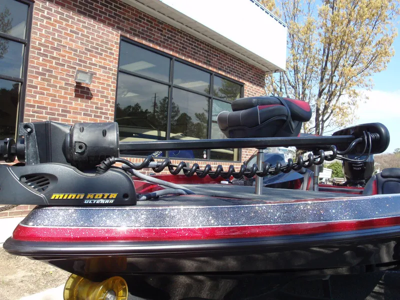 Slide: The Image of 2017 Ranger Z518 Comanche boat with Minn Kota trolling motor, parked outside a brick building. - 3