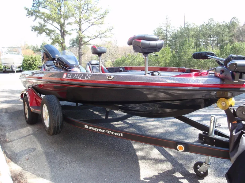 Slide: The Image of 2017 Ranger Z518 Comanche boat on trailer, parked outdoors with trees in background. - 4