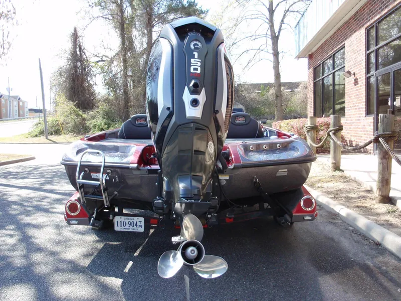 Slide: The Image of 2017 Ranger Z518 Comanche boat with powerful outboard motor, parked outdoors. - 5