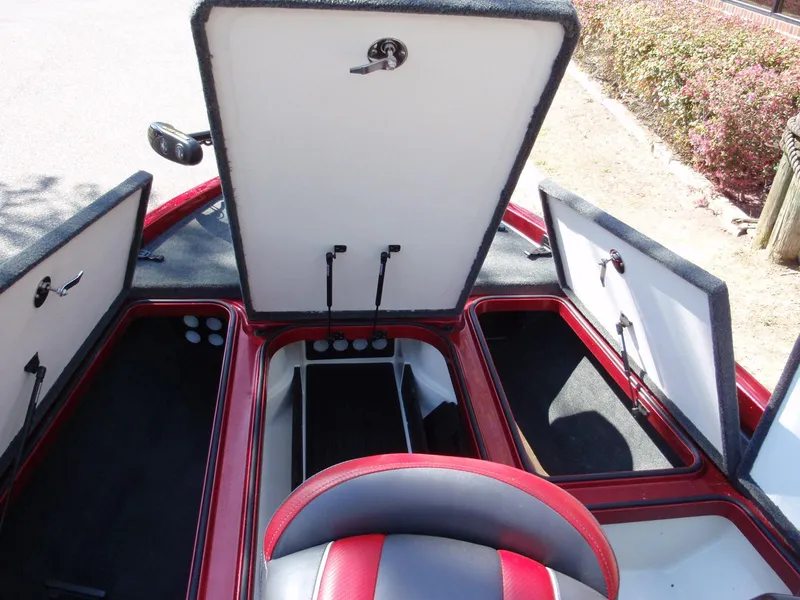 Slide: The Image of 2017 Ranger Z518 Comanche boat storage compartments open, showcasing interior space and design. - 9