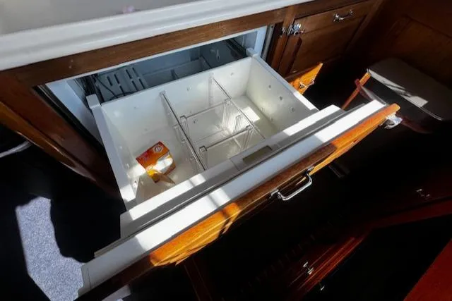 Slide: The Image of Open drawer refrigerator in 2003 Lyman-Morse Wesmac Sportfish Cruiser, featuring wooden cabinetry. - 11