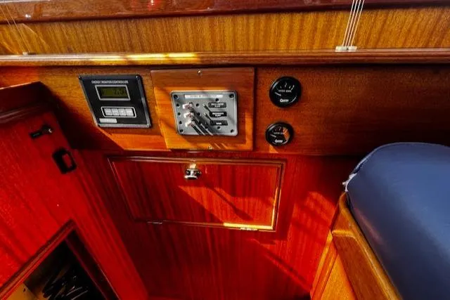 Slide: The Image of Control panel of 2003 Lyman-Morse Wesmac Sportfish Cruiser with wood finish and gauges. - 18