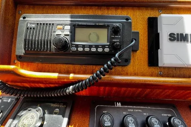 Slide: The Image of 2003 Lyman-Morse Wesmac Sportfish Cruiser radio and control panel with Icom and Simrad equipment. - 21