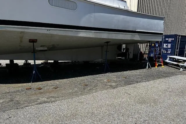 Slide: The Image of 2003 Lyman-Morse Wesmac Sportfish Cruiser on stands, side view, outdoor storage. - 23