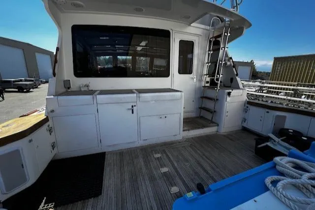 Slide: The Image of 2003 Lyman-Morse Wesmac Sportfish Cruiser deck with storage cabinets and ladder. - 31