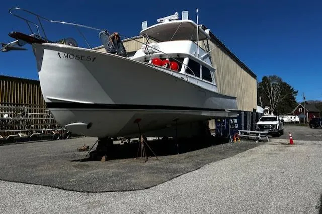 Slide: The Image of 2003 Lyman-Morse Wesmac Sportfish Cruiser on dry dock, outdoor storage area. - 35
