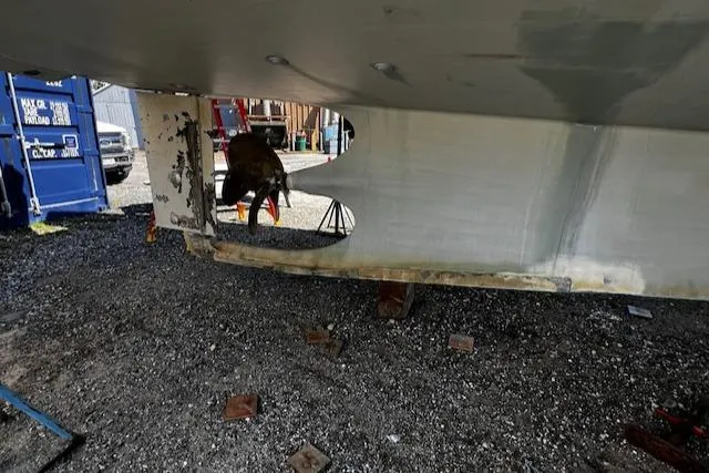 Slide: The Image of 2003 Lyman-Morse Wesmac Sportfish Cruiser under maintenance, showing hull and propeller. - 37