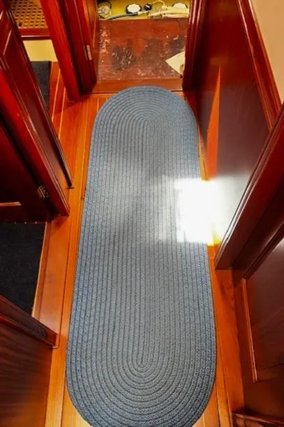 Slide: The Image of Blue oval rug on polished wooden floor of 2003 Lyman-Morse Wesmac Sportfish Cruiser. - 40