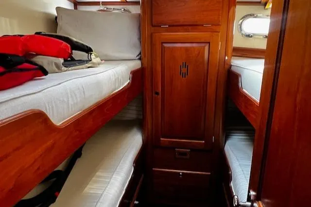 Slide: The Image of 2003 Lyman-Morse Wesmac Sportfish Cruiser cabin with wooden interior and bunk beds. - 43
