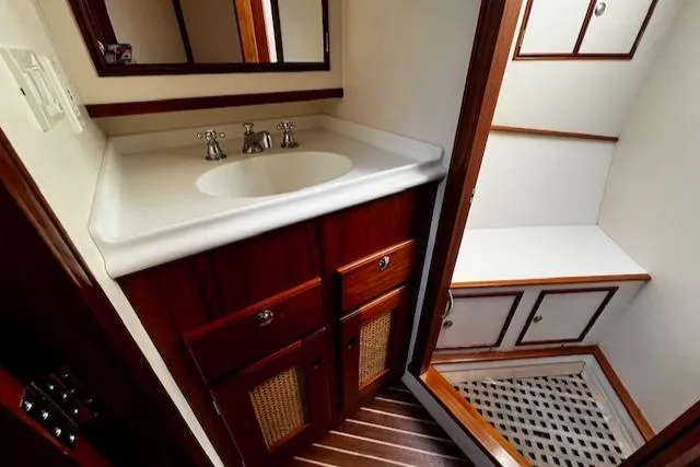 Slide: The Image of 2003 Lyman-Morse Wesmac Sportfish Cruiser bathroom with wooden cabinetry and white sink. - 47