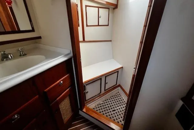 Slide: The Image of 2003 Lyman-Morse Wesmac Sportfish Cruiser bathroom with wooden cabinetry and white fixtures. - 48