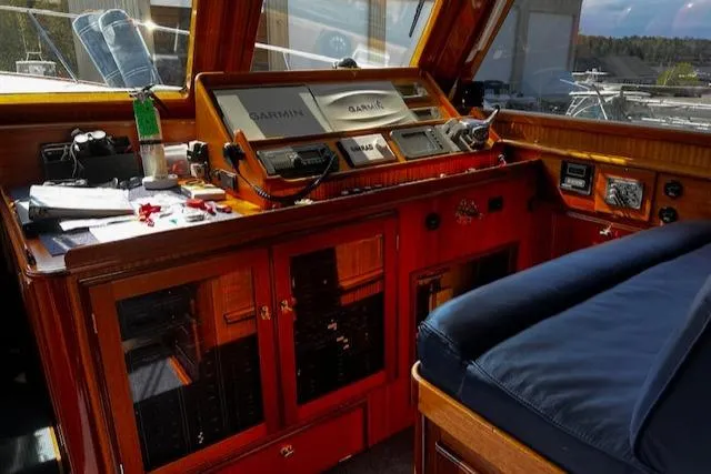 Slide: The Image of 2003 Lyman-Morse Wesmac Sportfish Cruiser helm with navigation equipment and wooden cabinetry. - 6