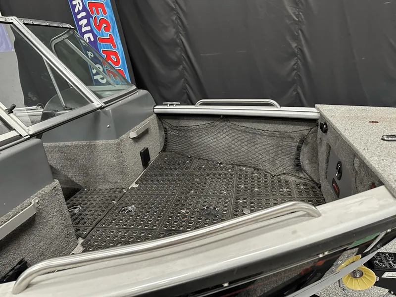 Slide: The Image of 2006 Lund 1800 Sport Angler boat interior with gray flooring and seating. - 12