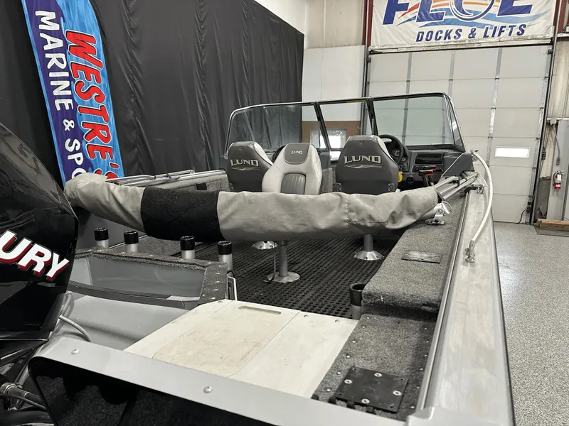 Slide: The Image of 2006 Lund 1800 Sport Angler boat interior with seats and fishing rod holders. - 13