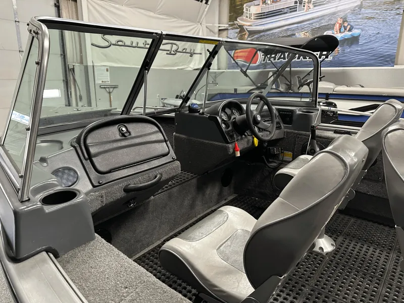 Slide: The Image of 2006 Lund 1800 Sport Angler boat interior with steering wheel and seating. - 15