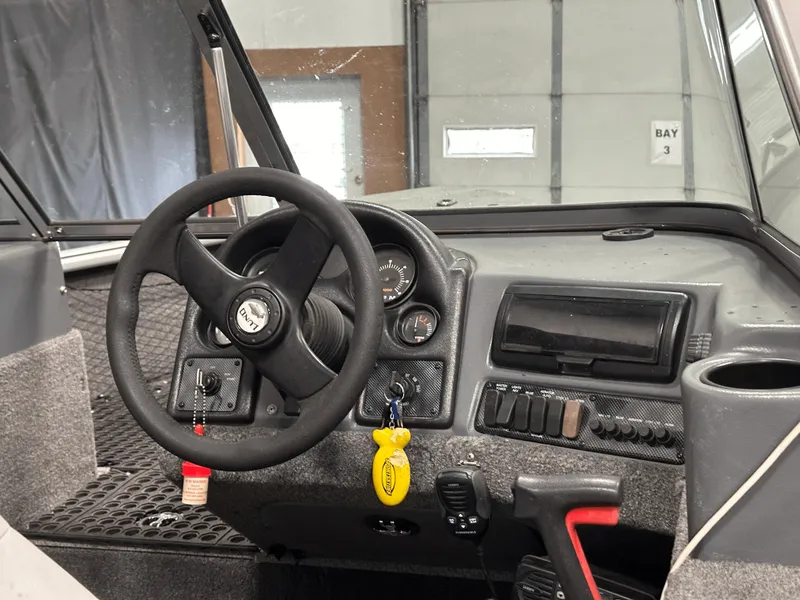 Slide: The Image of 2006 Lund 1800 Sport Angler dashboard with steering wheel and control panel. - 17