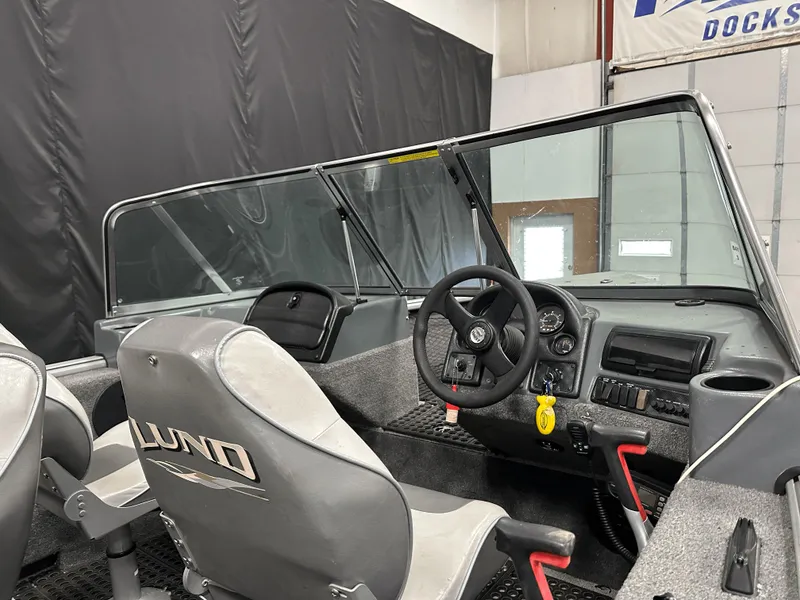 Slide: The Image of 2006 Lund 1800 Sport Angler boat interior with steering wheel and seating. - 18