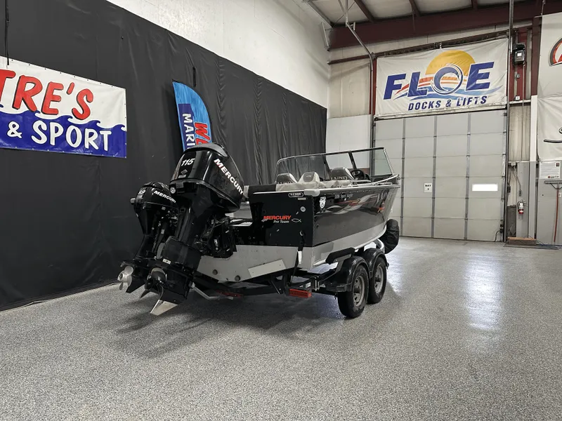 Slide: The Image of 2006 Lund 1800 Sport Angler boat in showroom with Mercury outboard motor. - 5
