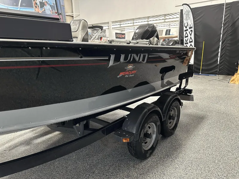 Slide: The Image of 2006 Lund 1800 Sport Angler boat on trailer, displayed indoors. - 9