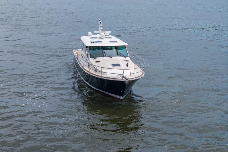 Slide: The Image of 2024 Sabre 43 Salon Express yacht cruising on open water. - 10