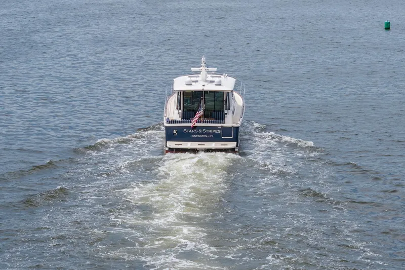 Slide: The Image of 2024 Sabre 43 Salon Express yacht cruising on open water. - 14