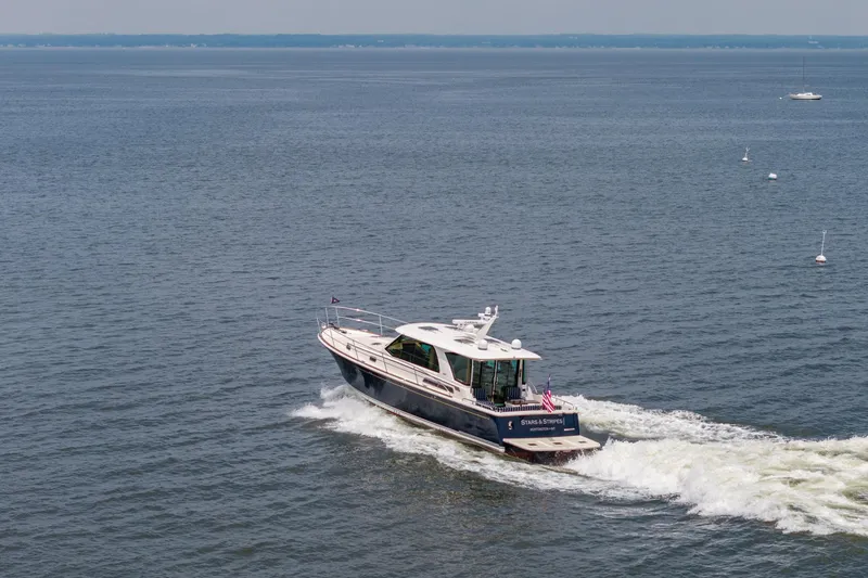 Slide: The Image of 2024 Sabre 43 Salon Express yacht cruising on open water. - 17